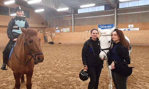 Three woman with horses